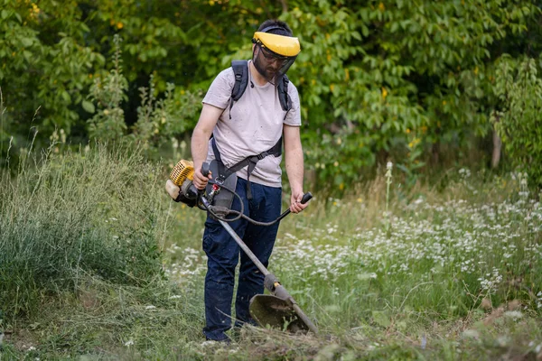 Young Caucasian Man Farmer Gardener Standing Field String Trimmer Petrol — Stockfoto