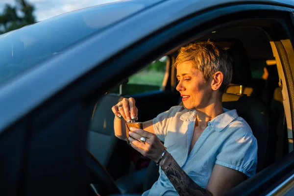 One Woman Mature Caucasian Female Tattoo Arms Hold Flask While — 스톡 사진