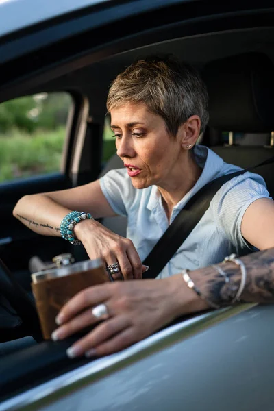 One Woman Mature Caucasian Female Tattoo Arms Hold Flask While — 스톡 사진