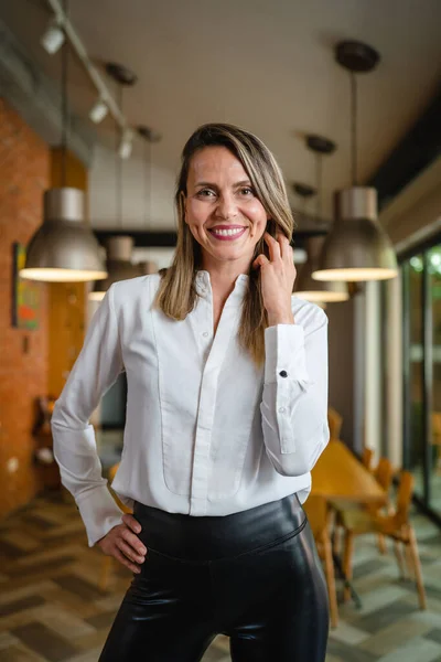 One woman middle age caucasian female standing at home in dining room or restaurant happy smile confident wear white shirt waist up copy space front view portrait