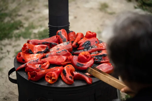 roasting paprika for winter provisions red organic peppers on the stove oven to be turned into ajvar a tasty spread popular in the Balkans Serbia Macedonia Bosnia and Croatia