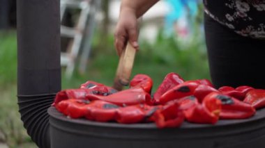 roasting paprika for winter provisions red organic peppers grill on the stove oven to be turned into ajvar a tasty spread unknown woman prepare food traditional way