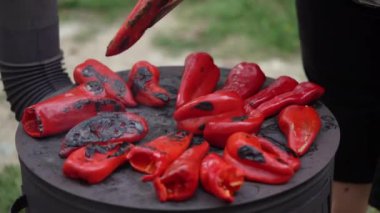 roasting paprika for winter provisions red organic peppers grill on the stove oven to be turned into ajvar a tasty spread unknown woman prepare food traditional way