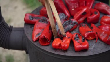 roasting paprika for winter provisions red organic peppers grill on the stove oven to be turned into ajvar a tasty spread unknown woman prepare food traditional way
