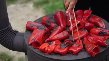 roasting paprika for winter provisions red organic peppers grill on the stove oven to be turned into ajvar a tasty spread unknown woman prepare food traditional way
