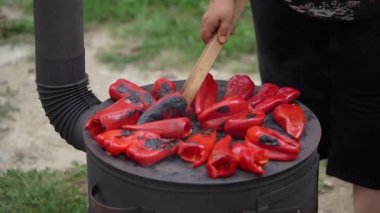 roasting paprika for winter provisions red organic peppers grill on the stove oven to be turned into ajvar a tasty spread unknown woman prepare food traditional way