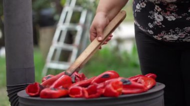 roasting paprika for winter provisions red organic peppers grill on the stove oven to be turned into ajvar a tasty spread unknown woman prepare food traditional way