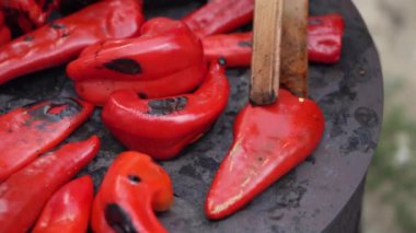 roasting paprika for winter provisions red organic peppers grill on the stove oven to be turned into ajvar a tasty spread unknown woman prepare food traditional way