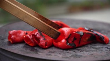roasting paprika for winter provisions red organic peppers grill on the stove oven to be turned into ajvar a tasty spread unknown woman prepare food traditional way