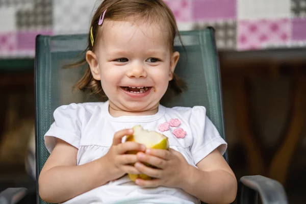 One Girl Small Caucasian Toddler Child Eat Pear While Sit Stock Image