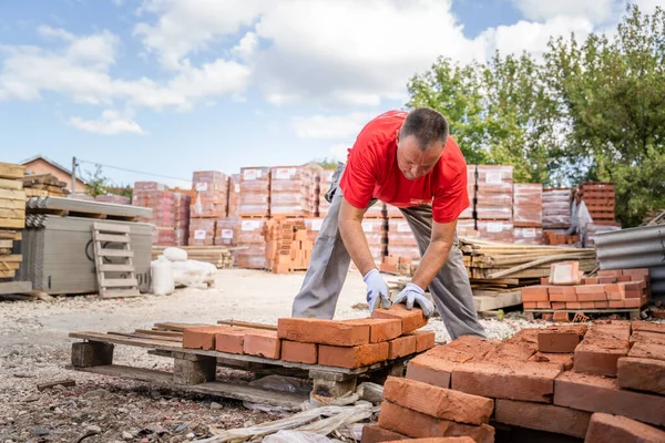 Caucasian Man Construction Industry Warehouse Worker Stacking Clay Brick Palette — Stockfoto