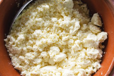 White cheese in clay plate pot