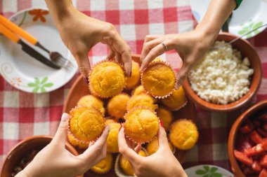 corn pone muffins in a plate on the table fresh baked ready to eat organic homemade food concept vegan or vegetarian traditional breakfast meal top view unknown people hands hold food