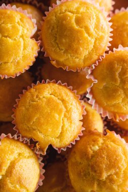 corn pone muffins in a plate on the table fresh baked ready to eat organic homemade food concept vegan or vegetarian traditional meal top view full frame close up macro background
