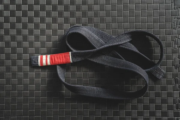 Brazilian jiu jitsu bjj black belt second degree on the tatami mats at gym or academy martial arts concept copy space
