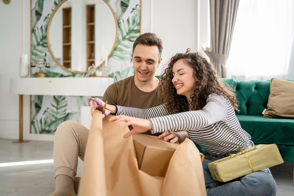 Stock image Couple man and woman prepare presents for holiday caucasian male and female packing gifts for friends using wrap paper happy smile hold gift box at home real people copy space