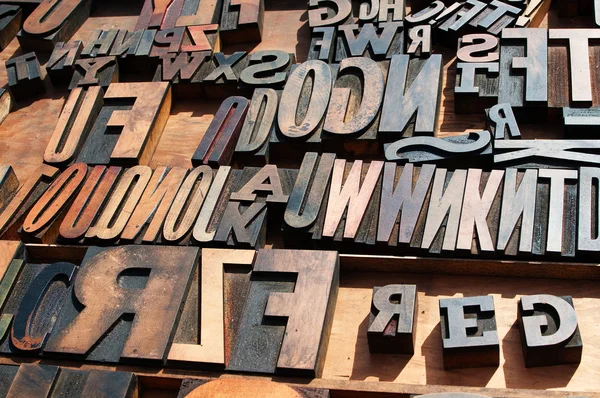 A bunch of old vintage wooden block printing press letters. Royalty Free Stock Photos
