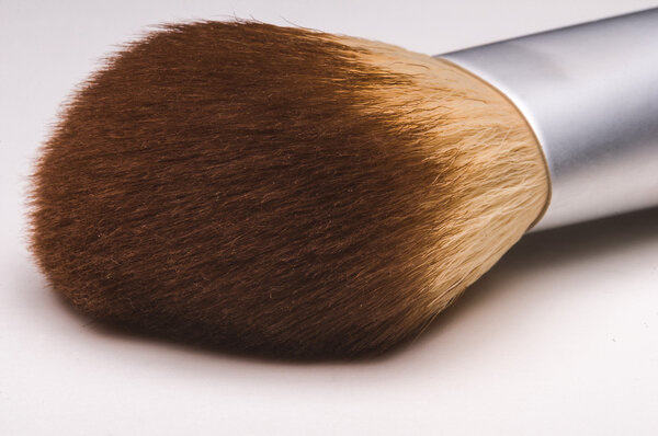 Make-up brush on white background.