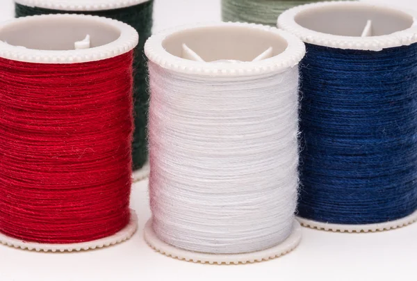 Colored spools of string on white background. — Stock Photo, Image