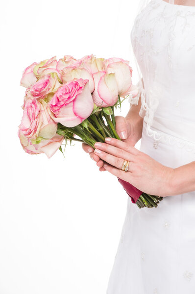 Young bride holding a bouquet on isolated white background.