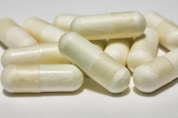 Bunch of capsules of medicine on white — Stock Photo, Image