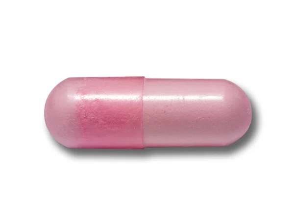 Cápsula rosa de medicamentos en blanco aislado — Foto de Stock