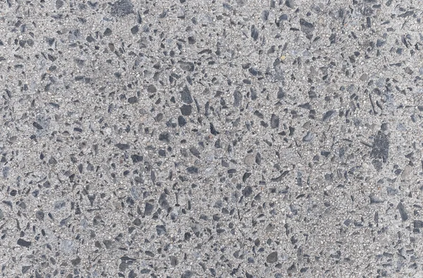 Suelo de hormigón gris con fondo de piedras —  Fotos de Stock