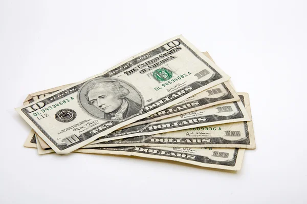 Ten-dollar bills spread out on white — Stock Photo, Image