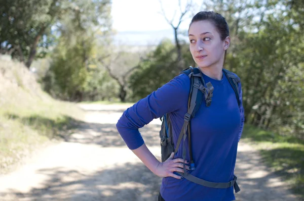 Hiker woman in blue long sleeve shirt looks away to left — Stock Photo, Image