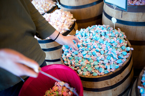 A woman reaches for blue salt water taffy