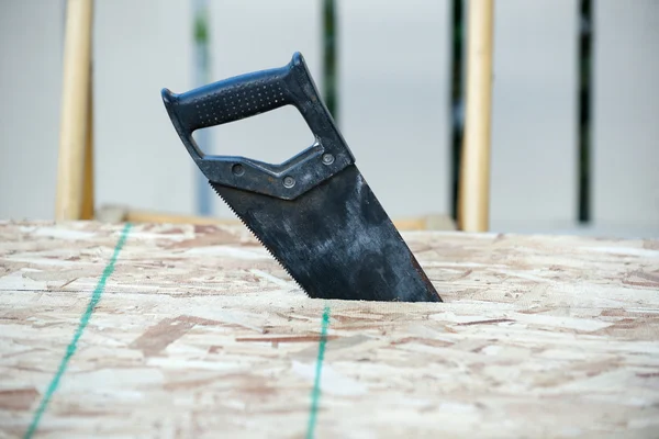 Side view of a hand saw in wood — Stock Photo, Image