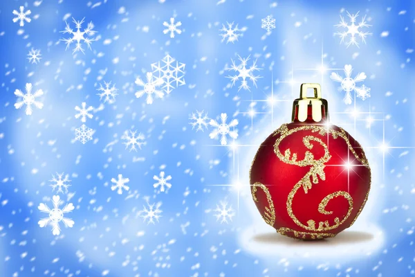 Red Christmas bauble with a snow backround — Stock Photo, Image