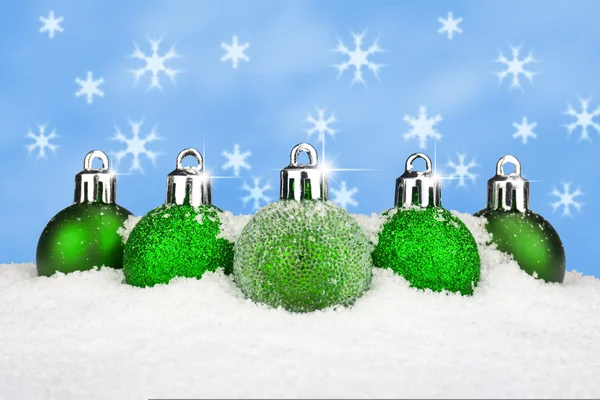 Green baubles in the snow — Stock Photo, Image