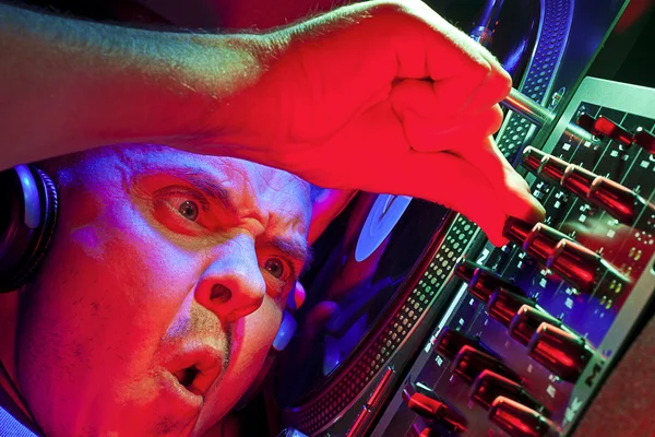 DJ enjoying music and controlling a mixer — Stock Photo, Image