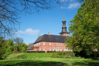 HUSUM, GERMANY - MAY 8, 2022: Husum Castle against blue sky, tourist attraction of Husum on May 8, 2022 in North Frisia, Germany