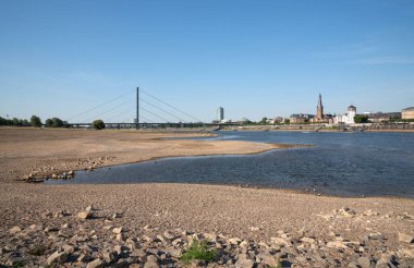 DUSSELDORF, GERMANY - AUGUST 11, 2022: Low water of the Rhine river in Dusseldorf, drought in North Rhine Westphalia on August 11, 2022 in Germany