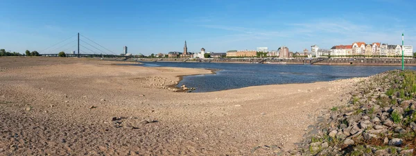 DUSSELDORF, GERMANY - AUGUST 11, 2022: Low water of the Rhine river in Dusseldorf, drought in North Rhine Westphalia on August 11, 2022 in Germany