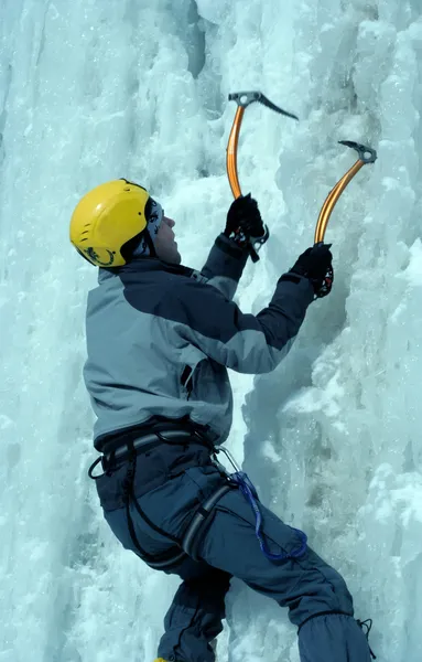 Man climbing frozen waterfall — Stock Photo, Image