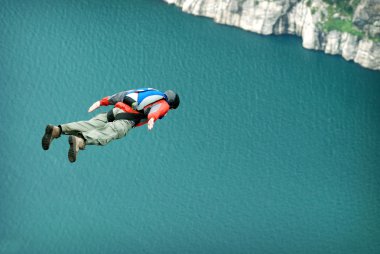 BASE jump off a cliff. clipart