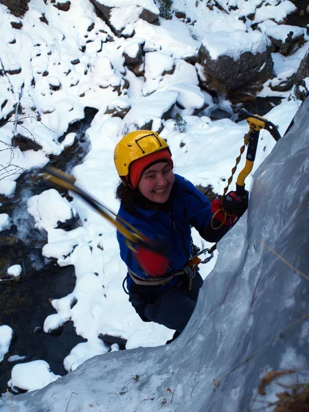 Man climbing frozen waterfall — Stock Photo, Image