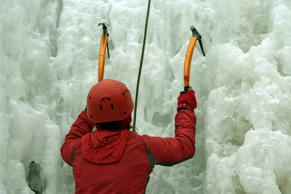 Man climbing frozen waterfall — Stock Photo, Image