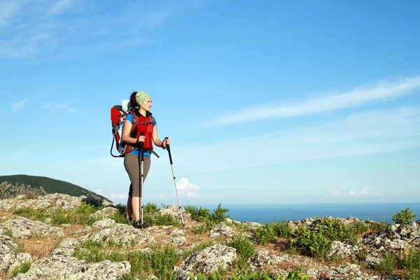 Mother with baby carrier carrying a son in alps on a sunny day — Stock Photo, Image