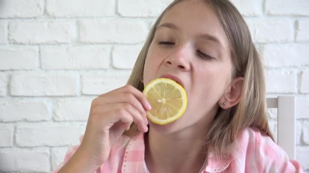 Child Eating Lemon, Child Eats Fruits, Young Girl at Breakfast in Kitchen, Children Healthcare — Stock Video