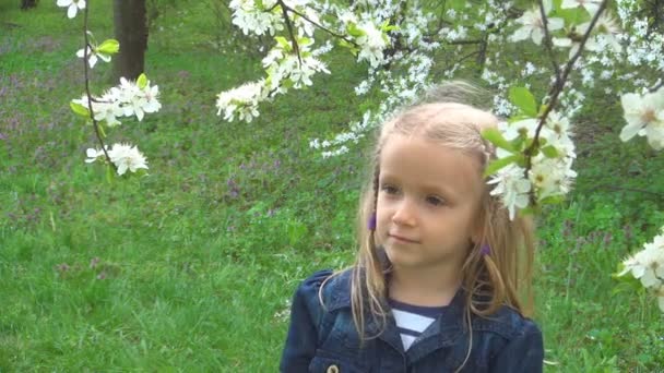 Kid Smelling Flowers Child Playing Spring Flowers Orchard Smiling Girl — стокове відео