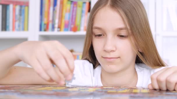 Niño haciendo rompecabezas, Niño aburrido jugando juegos inteligentes en casa, Adolescente chica juega juegos de mesa en interiores — Vídeo de stock