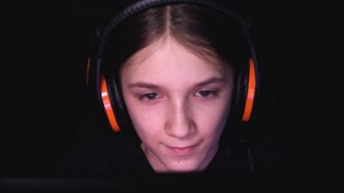 Kid Playing Video Games on Laptop, Desktop in Night, Headphones Child Browsing Internet on Computer, Girl in Conferencing Online