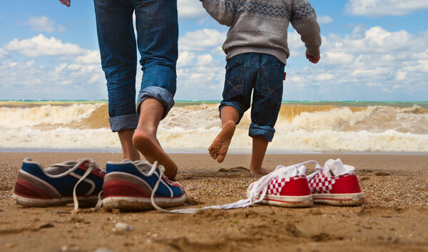 Father and son walk at the seaside