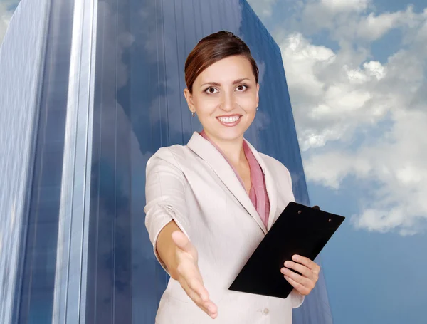 Smiling business woman with hand outstretched for a handshake — Stock Photo, Image