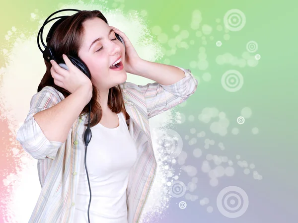 Portrait of singing cute teenage girl in headphones — Stock Photo, Image