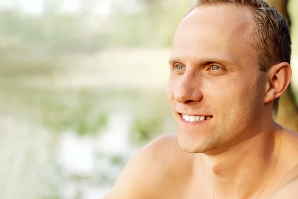 Happy young man portrait near the river — Stock Photo, Image